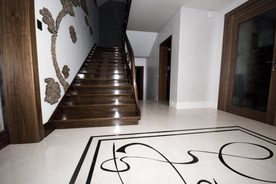 Hallway with stone marquetry on the floor. Fused glass in the belfry.