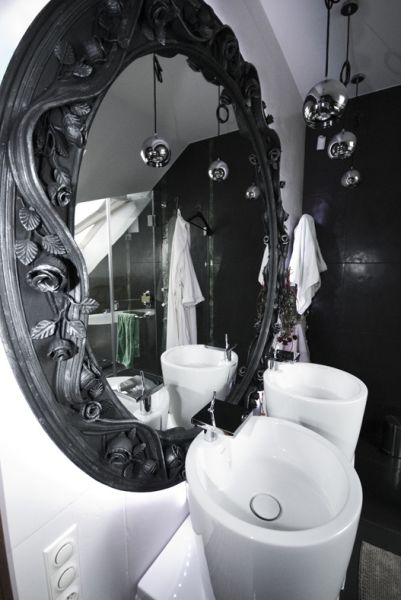 Bathroom with wrought iron mirror frame.